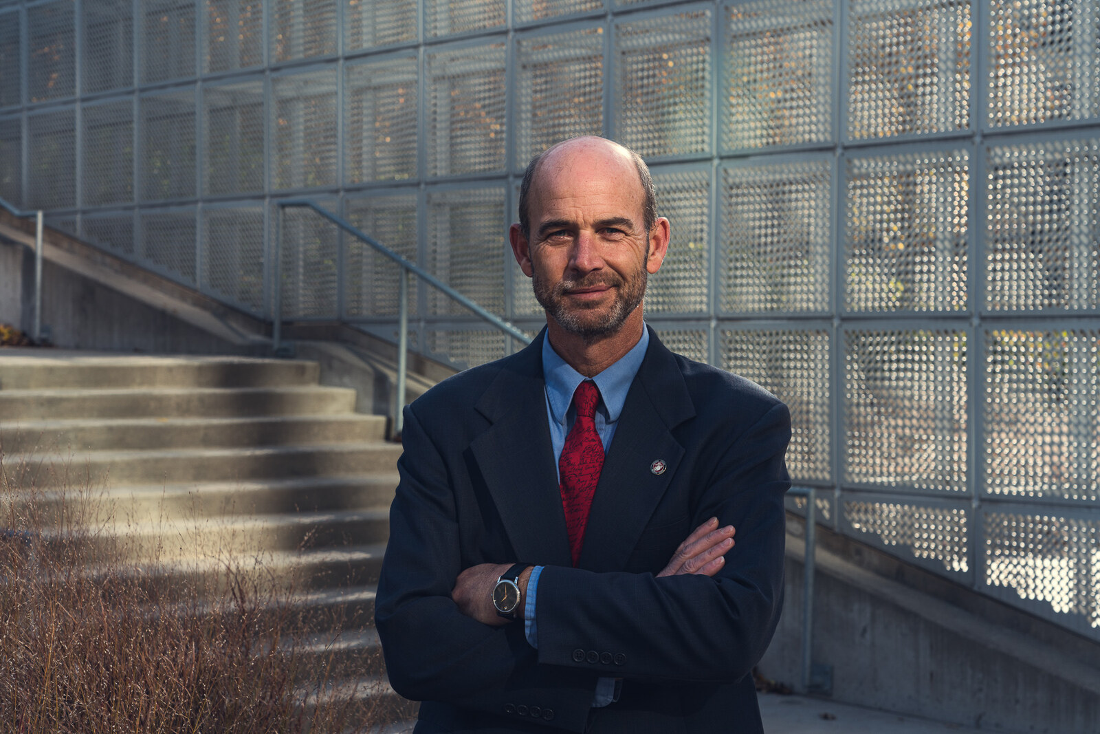 Executive portrait against a glass block wall