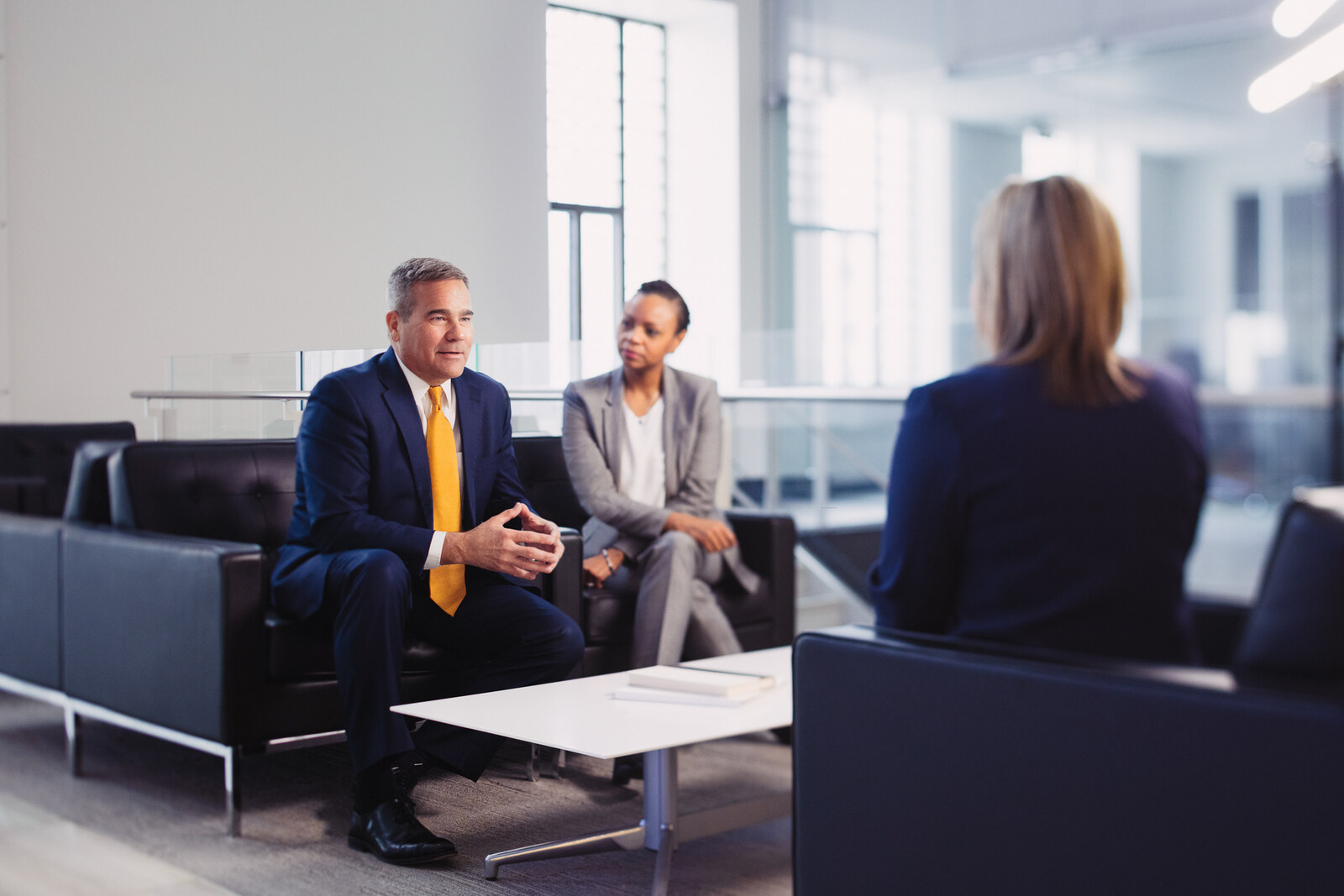 Annual report portrait, three colleagues in a bright office